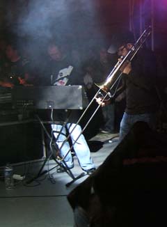 image of a trombone player in a dark smoky environement