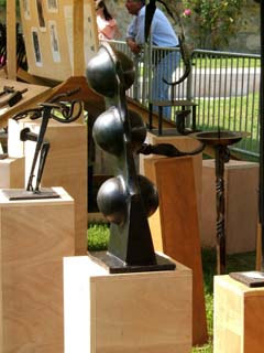 A variety of iron sculpture was presented on wood pedastals.