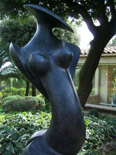 An abstracted danser in a somewhat "Archipenko" style of polished and patinated bronze has sensuous lines and geometric forms for features but remains clearly figuritive.
