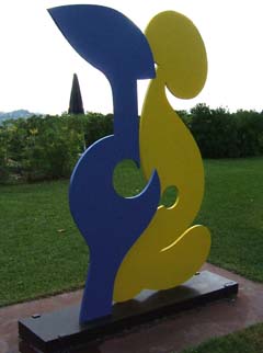Two abstract figures, one in blue with sharp corners, the other in yellow with rounded corners.