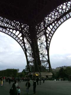 A view of the open terrace under the tower.  The people recede into the distance across the terrace to give someindication of the scale of the tower which looms large overhead.