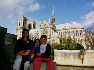 My family in the foreground and the famous "Notre Dame" cathedral in the background across the Seine river.