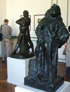 Two sculptures of Balzac.  The one in the foreground wears a large robe while the one in the background is nude.