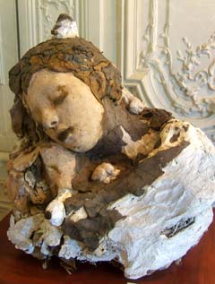 A rough collection of parts pasted together with plaster and modified in places with wax depicts a young woman sleeping.