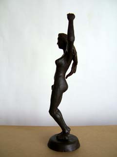 One of the wax originals.  Realistic female figure of a dancer in dark browm wax.