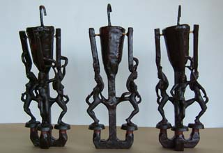 Wax orignals of female figures dancing are attached in groups of 3, 2 and 3 to a central sprue bar with a pour cup on top.  The metal will flow into the original from the bottom and vented out the top of the figures.  Several additional paths are provided for the metal to ensure that even the smallest portions are filled properly.