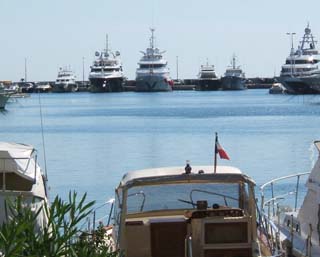 cascade of similar forms.  Yachts of various sizes stacked side by side at the new port in Cannes.