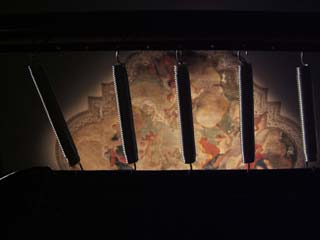 View from below a trampoline through the springs towards a classical religious fresco.