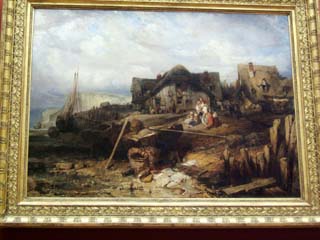 A French classical painting of two houses at the seashore.  The whole scene presents a general dilapidation that must have been based, at least in part, on reality.