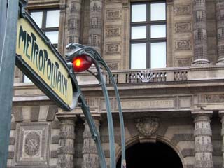 Image of the Art Nuveau entrance to the Paris Metro in front of the Louvre.