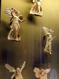 femal figures with wings look like angels.  Clay prints of the goddess Nike.