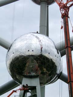 "close up" of the Atomium includes tiny images of workers on top and suspended below one of the 56 foot diameter shperes.