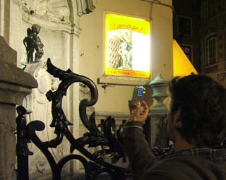 A fountian made of a bronze statue of a little boy peeing.