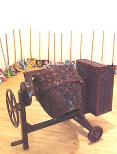 An elaborately carved woden model of a cement mixer.